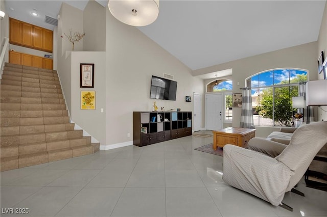 1335 Passiflora Dr, Henderson, NV 89002 - living room with high vaulted ceiling, stairs, baseboards, and light tile patterned floors