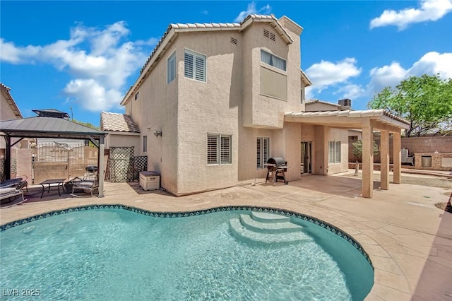 1335 Passiflora Dr, Henderson, NV 89002 - back of property featuring a gazebo, stucco siding, a patio area, and a tile roof