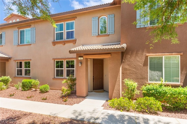 11402 Newton Commons Dr Unit 102, Las Vegas, NV 89135 - view of front facade featuring a tile roof and stucco siding