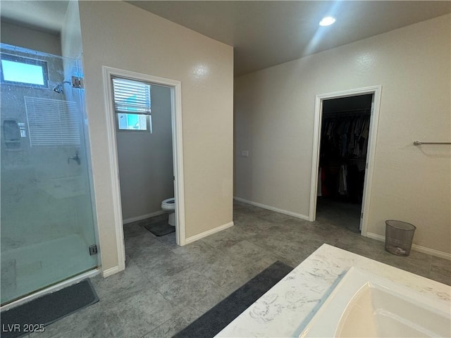 933 Kimbark Ave, Las Vegas, NV 89148 - bathroom featuring a shower stall, toilet, and a walk in closet