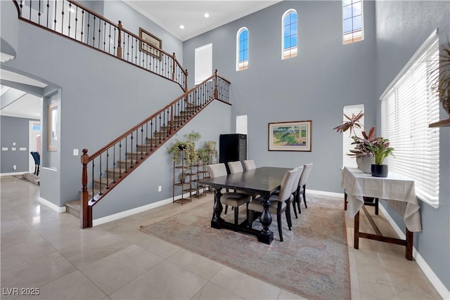 8268 Nelson Ridge Ln, Las Vegas, NV 89178 - dining space featuring a high ceiling, baseboards, stairs, ornamental molding, and arched walkways