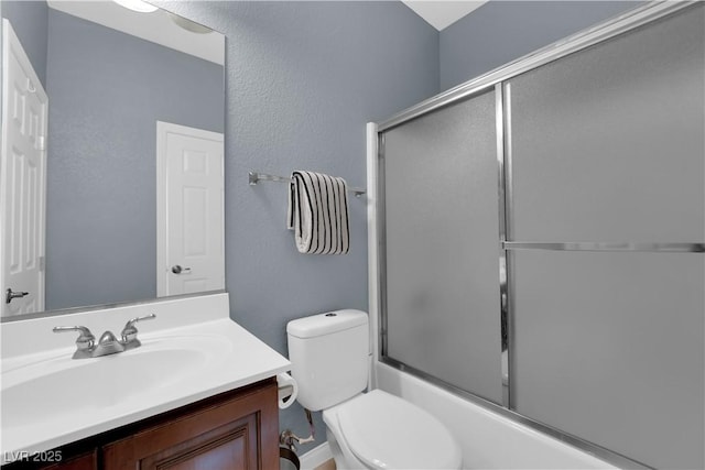 8268 Nelson Ridge Ln, Las Vegas, NV 89178 - bathroom featuring toilet, vanity, bath / shower combo with glass door, and a textured wall