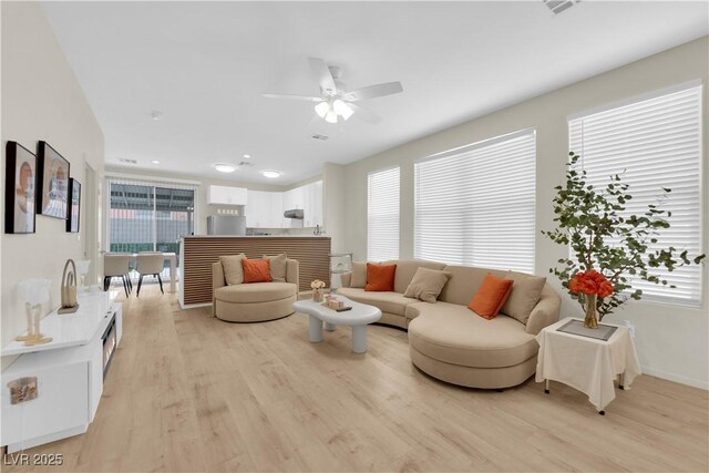 2633 Spider Cactus Ct, Las Vegas, NV 89106 - living area with light wood-style floors, a ceiling fan, and healthy amount of natural light