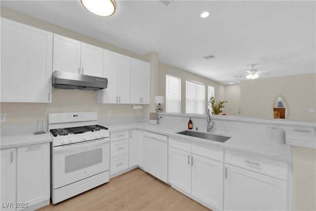 2633 Spider Cactus Ct, Las Vegas, NV 89106 - kitchen featuring white appliances, under cabinet range hood, a sink, white cabinetry, and recessed lighting