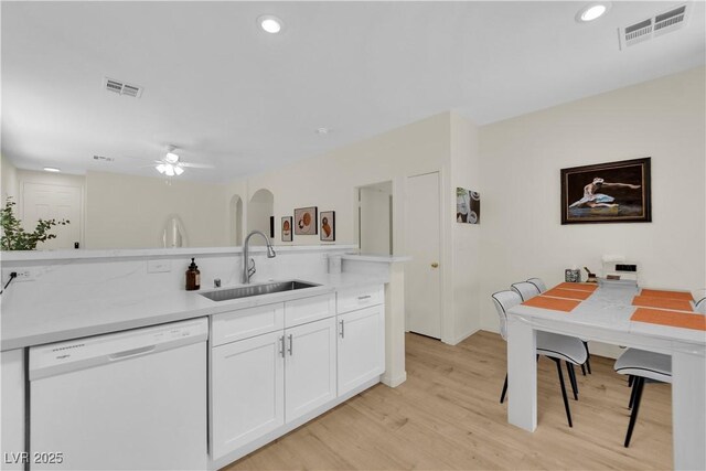 2633 Spider Cactus Ct, Las Vegas, NV 89106 - kitchen featuring white dishwasher, a sink, ceiling fan, white cabinets, and light wood-style flooring