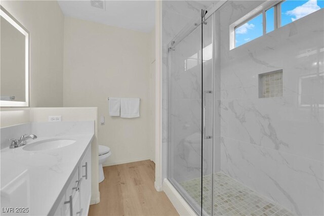 2633 Spider Cactus Ct, Las Vegas, NV 89106 - bathroom featuring vanity, a marble finish shower, toilet, and wood finished floors