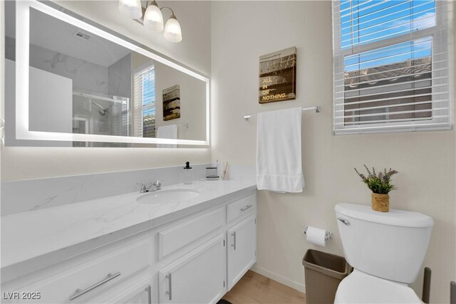 2633 Spider Cactus Ct, Las Vegas, NV 89106 - bathroom with vanity, toilet, an enclosed shower, and baseboards
