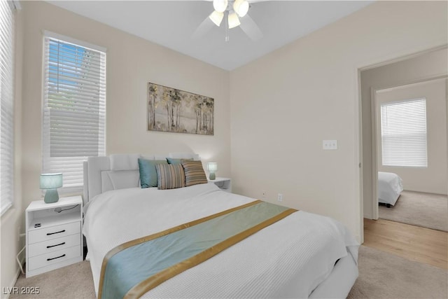 2633 Spider Cactus Ct, Las Vegas, NV 89106 - bedroom with light colored carpet, a ceiling fan, and light wood finished floors