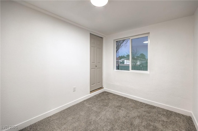 1731 Sherwin Ln, Las Vegas, NV 89156 - empty room featuring dark carpet and baseboards