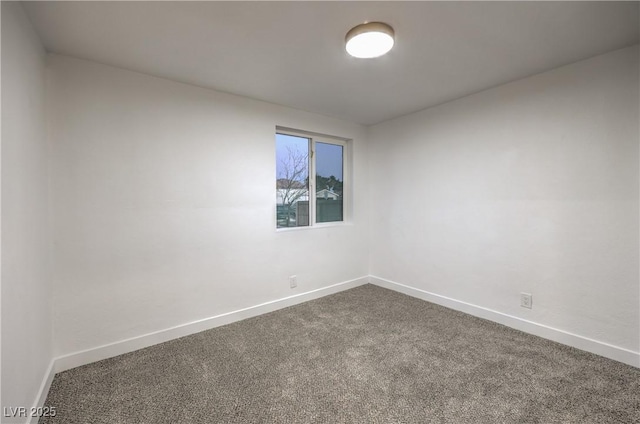 1731 Sherwin Ln, Las Vegas, NV 89156 - spare room featuring dark colored carpet and baseboards