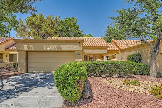 9024 Starmount Dr, Las Vegas, NV 89134 - view of front of property featuring a tiled roof, an attached garage, stucco siding, and driveway