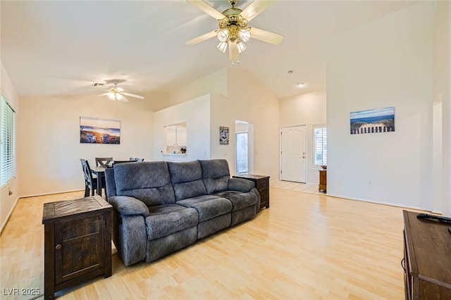 9024 Starmount Dr, Las Vegas, NV 89134 - living room with ceiling fan, light wood-style flooring, high vaulted ceiling, and baseboards