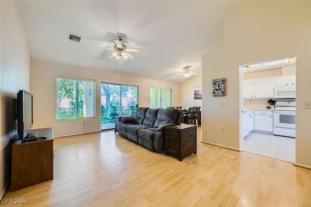 9024 Starmount Dr, Las Vegas, NV 89134 - living area featuring a ceiling fan, light wood finished floors, lofted ceiling, and baseboards