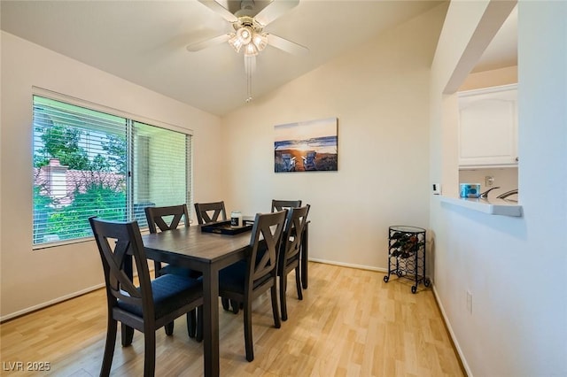 9024 Starmount Dr, Las Vegas, NV 89134 - dining area featuring light wood-style flooring, vaulted ceiling, a ceiling fan, and baseboards