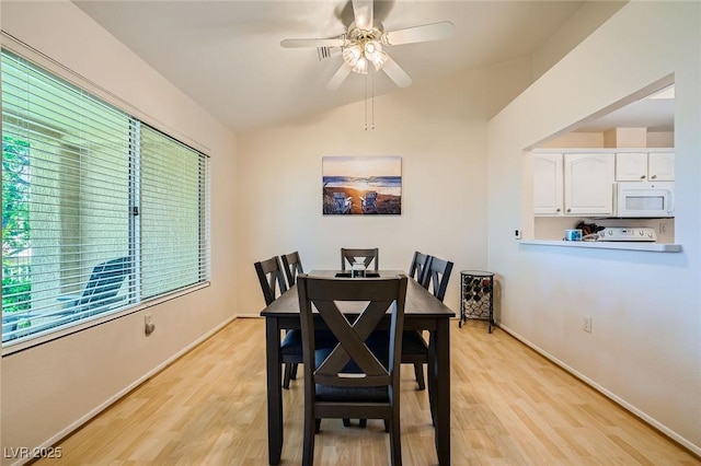 9024 Starmount Dr, Las Vegas, NV 89134 - dining area with light wood finished floors, ceiling fan, lofted ceiling, and baseboards