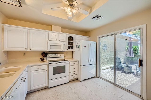 9024 Starmount Dr, Las Vegas, NV 89134 - kitchen featuring white appliances, a sink, white cabinetry, and light tile patterned floors