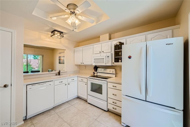 9024 Starmount Dr, Las Vegas, NV 89134 - kitchen with white appliances, a raised ceiling, white cabinets, and light countertops