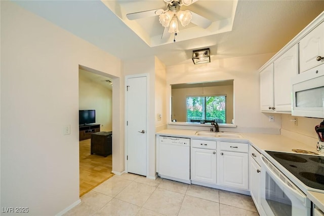 9024 Starmount Dr, Las Vegas, NV 89134 - kitchen with white appliances, a sink, ceiling fan, a tray ceiling, and white cabinets