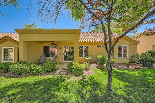 9024 Starmount Dr, Las Vegas, NV 89134 - back of property with a ceiling fan, a lawn, and a tile roof