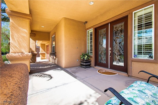 10798 Tapestry Winds St, Las Vegas, NV 89141 - view of exterior entry featuring stucco siding, french doors, and a porch