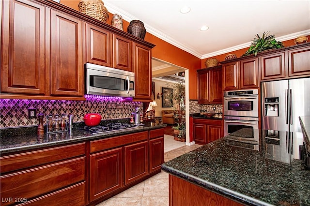 10798 Tapestry Winds St, Las Vegas, NV 89141 - kitchen featuring stainless steel appliances, tasteful backsplash, ornamental molding, light tile patterned flooring, and dark stone countertops