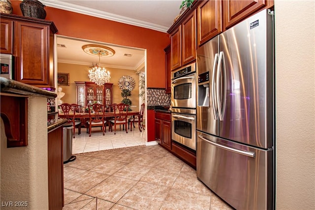 10798 Tapestry Winds St, Las Vegas, NV 89141 - kitchen featuring stainless steel appliances, ornamental molding, a chandelier, dark countertops, and light tile patterned floors