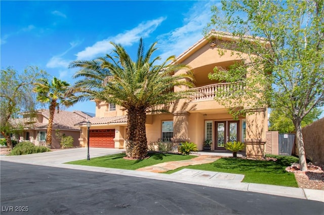 10798 Tapestry Winds St, Las Vegas, NV 89141 - mediterranean / spanish home featuring a balcony, stucco siding, a garage, driveway, and french doors