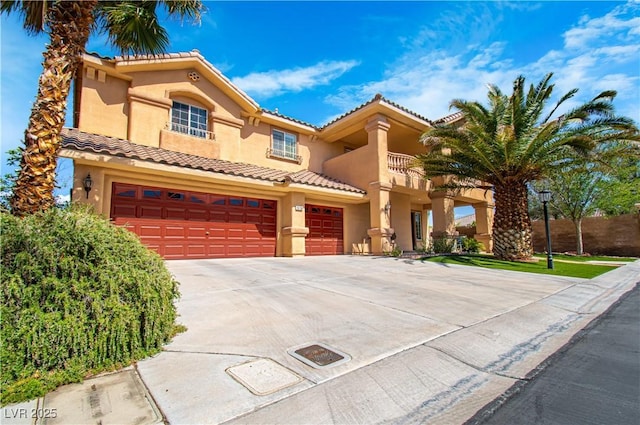10798 Tapestry Winds St, Las Vegas, NV 89141 - mediterranean / spanish-style house featuring concrete driveway, an attached garage, stucco siding, and a tiled roof