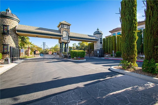 10798 Tapestry Winds St, Las Vegas, NV 89141 - view of asphalt street featuring a gate, a gated entry, and curbs