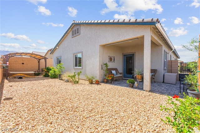 10951 Stone Crossing Ave, Las Vegas, NV 89166 - back of property with stucco siding, a patio area, and a pergola