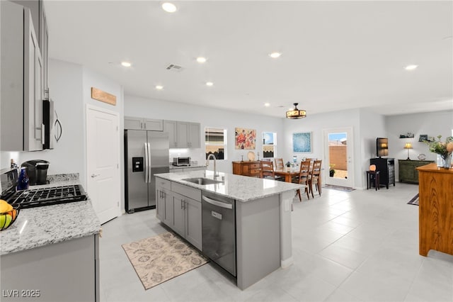 10951 Stone Crossing Ave, Las Vegas, NV 89166 - kitchen featuring appliances with stainless steel finishes, a sink, gray cabinets, light stone counters, and recessed lighting