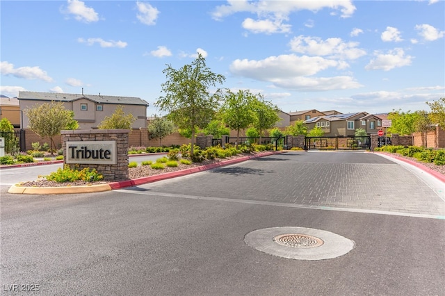 10951 Stone Crossing Ave, Las Vegas, NV 89166 - view of asphalt street featuring a residential view, curbs, a gated entry, and traffic signs