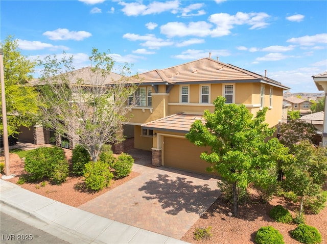10315 Turia Gardens Rd, Las Vegas, NV 89135 - view of front of property featuring stucco siding, a garage, decorative driveway, and a tiled roof