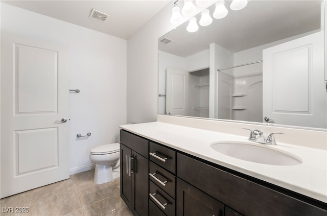 10315 Turia Gardens Rd, Las Vegas, NV 89135 - full bath featuring vanity, toilet, a shower, baseboards, and tile patterned floors