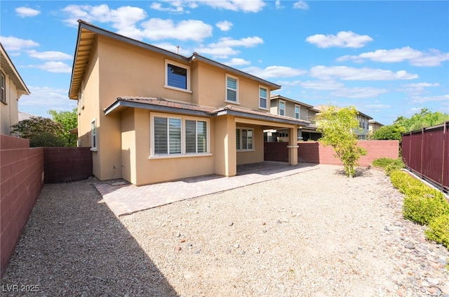 10315 Turia Gardens Rd, Las Vegas, NV 89135 - rear view of house with stucco siding, a fenced backyard, and a patio