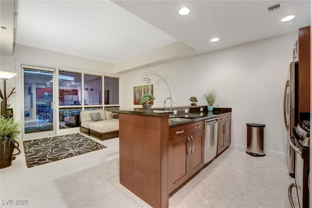 4525 Dean Martin Dr Unit 2901, Las Vegas, NV 89103 - kitchen featuring appliances with stainless steel finishes, dark countertops, a sink, open floor plan, and a peninsula