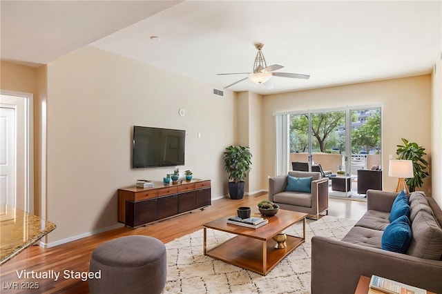 8255 Las Vegas Blvd Unit 117, Las Vegas, NV 89123 - living room with light wood-style floors, a ceiling fan, and baseboards