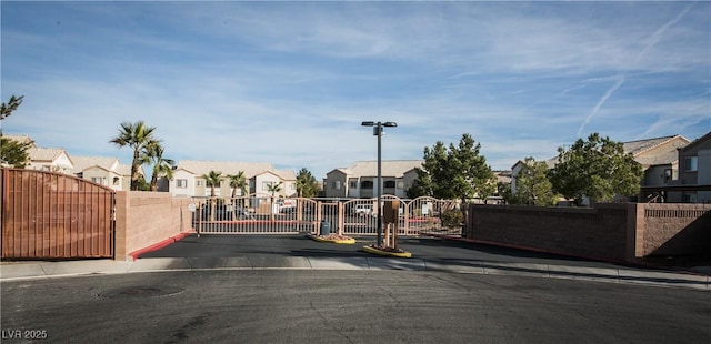 4655 Gold Dust Ave Unit 206, Las Vegas, NV 89120 - view of asphalt street with a residential view, a gate, curbs, and a gated entry
