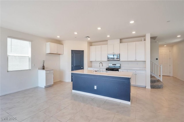 5398 Robinera Ct, Las Vegas, NV 89166 - kitchen with stainless steel appliances, a sink, white cabinetry, and recessed lighting