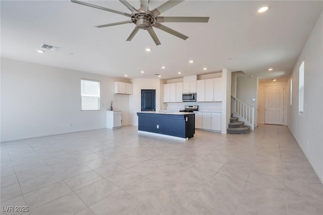 5398 Robinera Ct, Las Vegas, NV 89166 - unfurnished living room with recessed lighting, stairs, ceiling fan, and light tile patterned floors