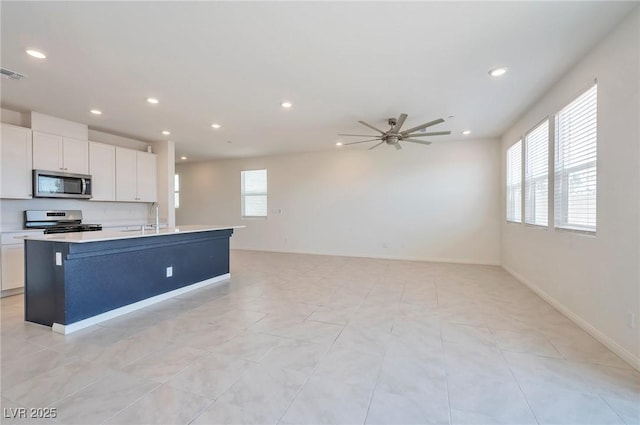 5398 Robinera Ct, Las Vegas, NV 89166 - kitchen featuring stainless steel appliances, a sink, recessed lighting, a ceiling fan, and white cabinetry