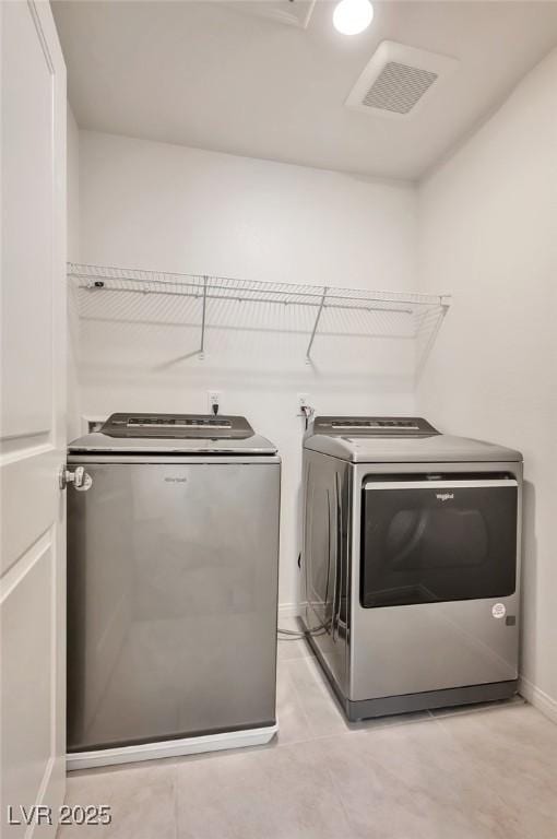 5398 Robinera Ct, Las Vegas, NV 89166 - laundry room with washer and dryer, baseboards, and light tile patterned floors