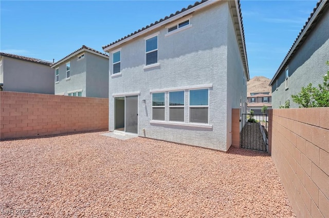 5398 Robinera Ct, Las Vegas, NV 89166 - back of house with stucco siding, a fenced backyard, and a tiled roof