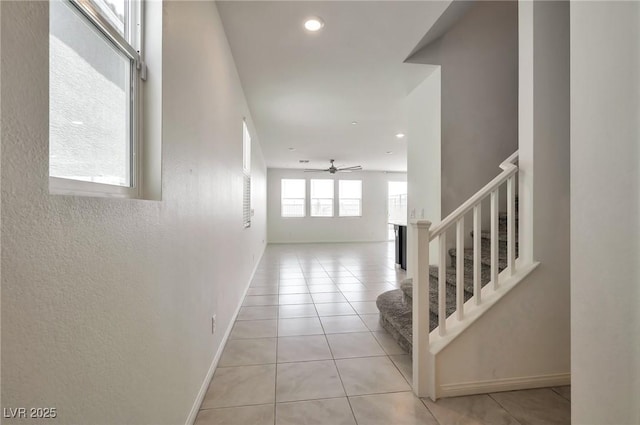 5398 Robinera Ct, Las Vegas, NV 89166 - hall with stairs, light tile patterned floors, baseboards, and recessed lighting