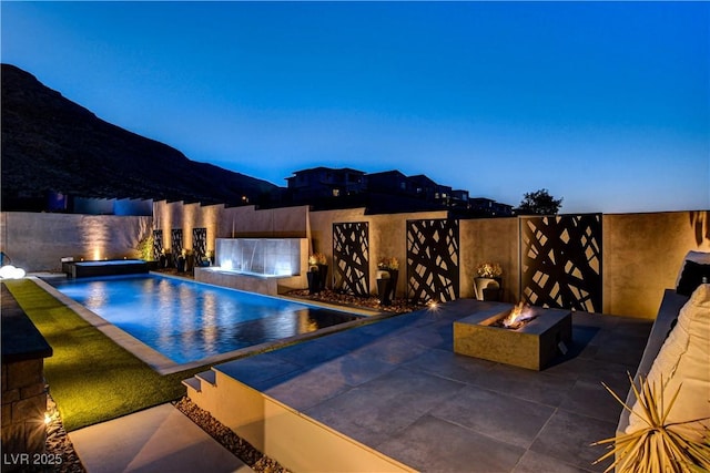 10228 Shell Star Ave, Las Vegas, NV 89135 - view of pool featuring a fire pit, a hot tub, a patio, and a fenced backyard