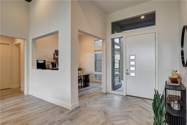 10228 Shell Star Ave, Las Vegas, NV 89135 - foyer featuring a towering ceiling, baseboards, and parquet floors