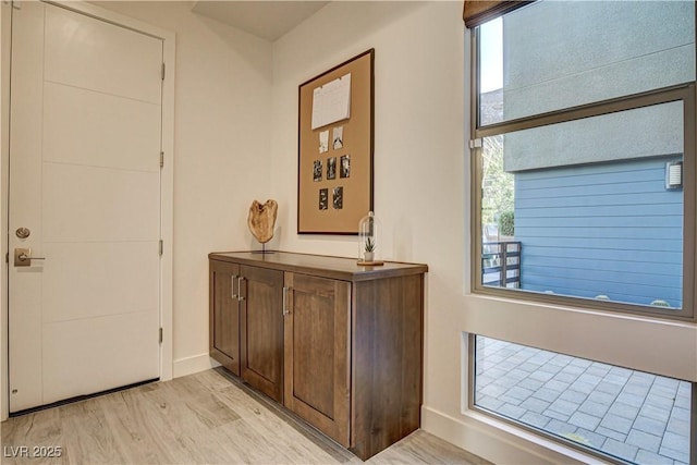 10228 Shell Star Ave, Las Vegas, NV 89135 - foyer entrance with healthy amount of natural light, baseboards, and light wood-style flooring