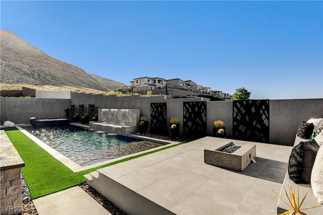 10228 Shell Star Ave, Las Vegas, NV 89135 - view of pool featuring an outdoor fire pit, a patio, and a fenced backyard