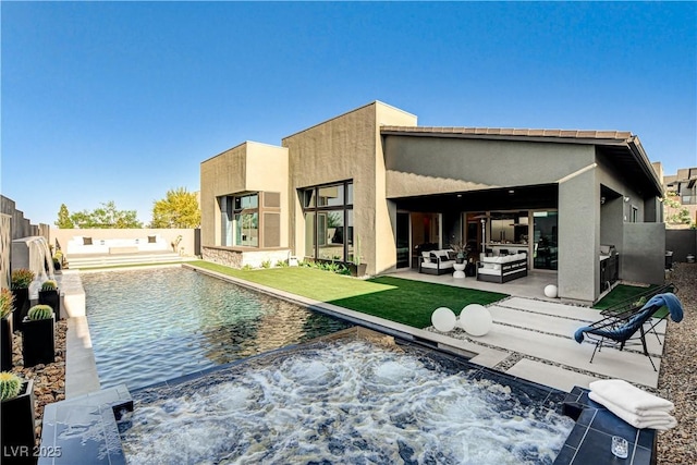 10228 Shell Star Ave, Las Vegas, NV 89135 - back of property with an in-ground hot tub, an outdoor living space, a patio area, stucco siding, and a fenced backyard