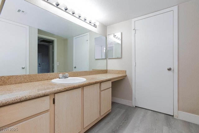 555 E Silverado Ranch Blvd Unit 2164, Las Vegas, NV 89183 - bathroom featuring wood finished floors, vanity, and baseboards